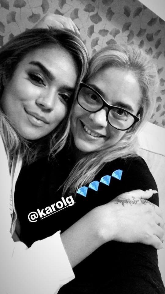 Two women are hugging each other in a black and white photo.