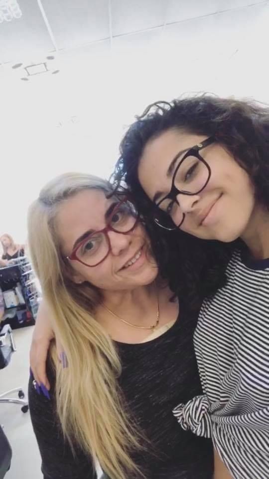 Two girls wearing glasses are posing for a picture together