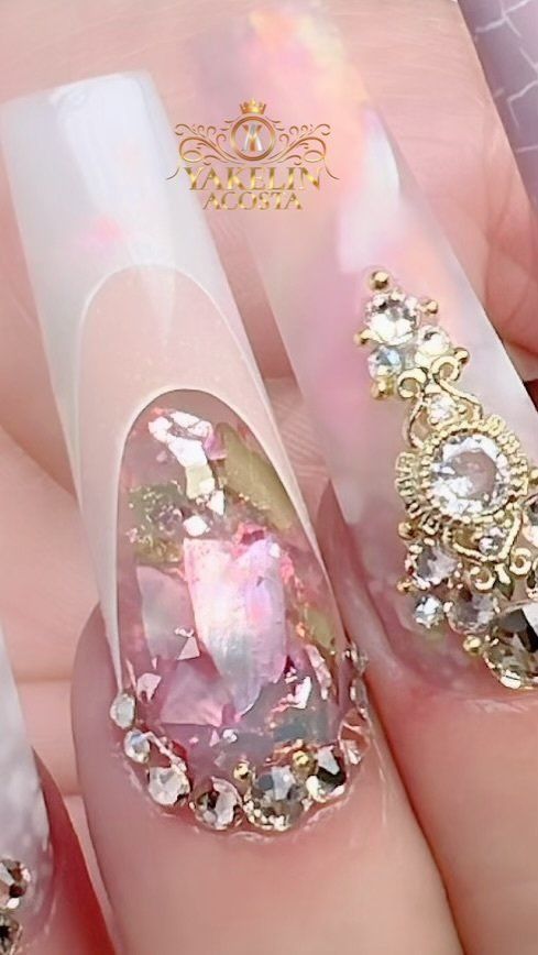 A close up of a person 's nails with rhinestones on them.