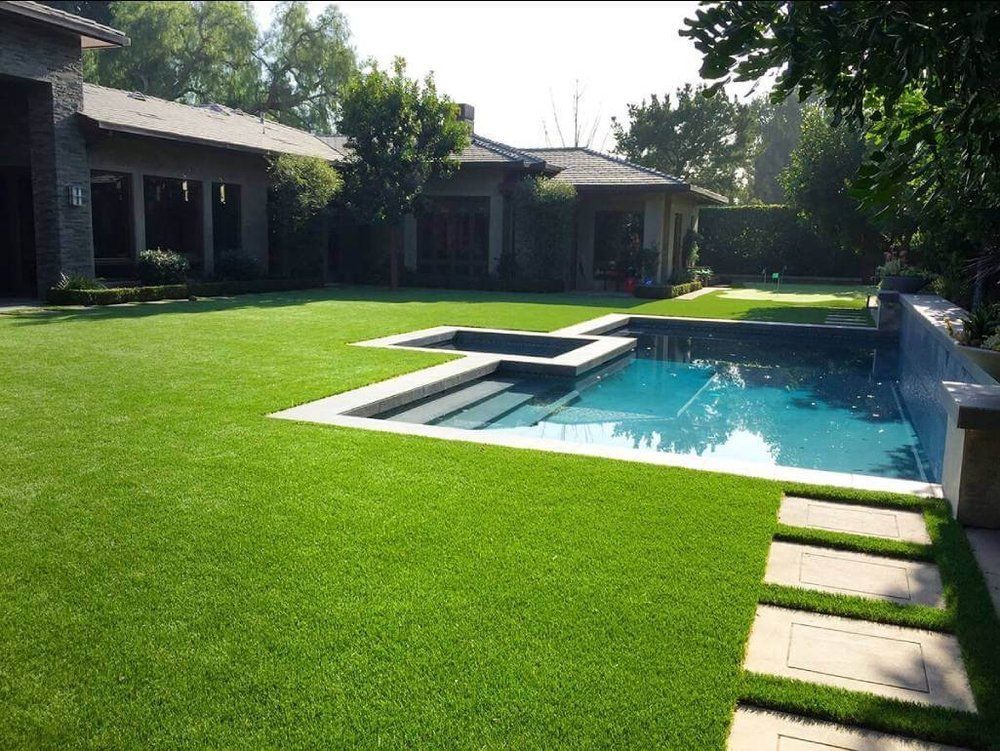 A large house with a swimming pool in the backyard