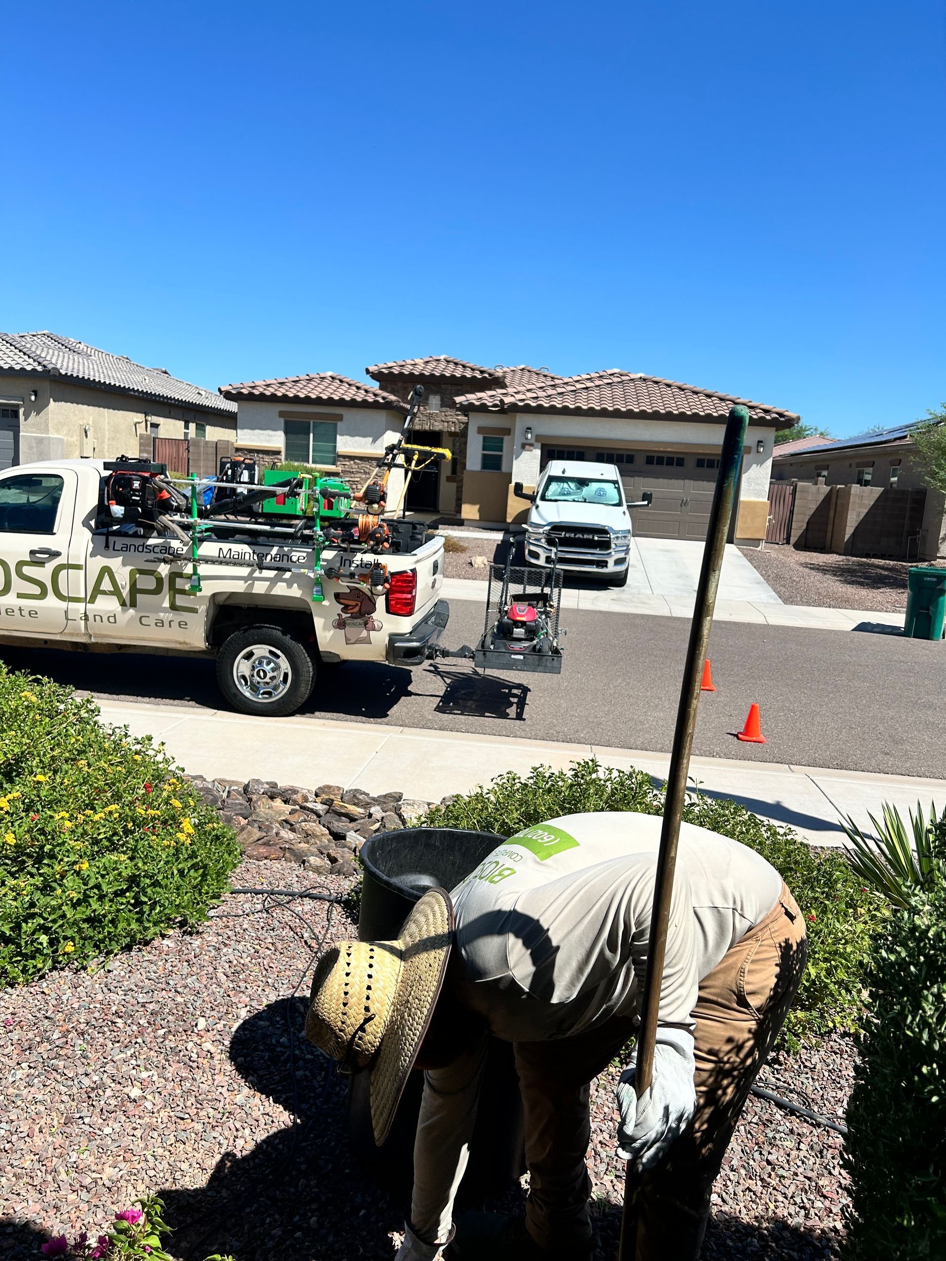 A landscape truck is parked in front of a house