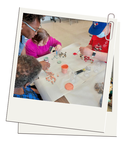 A group of people are sitting around a table making crafts