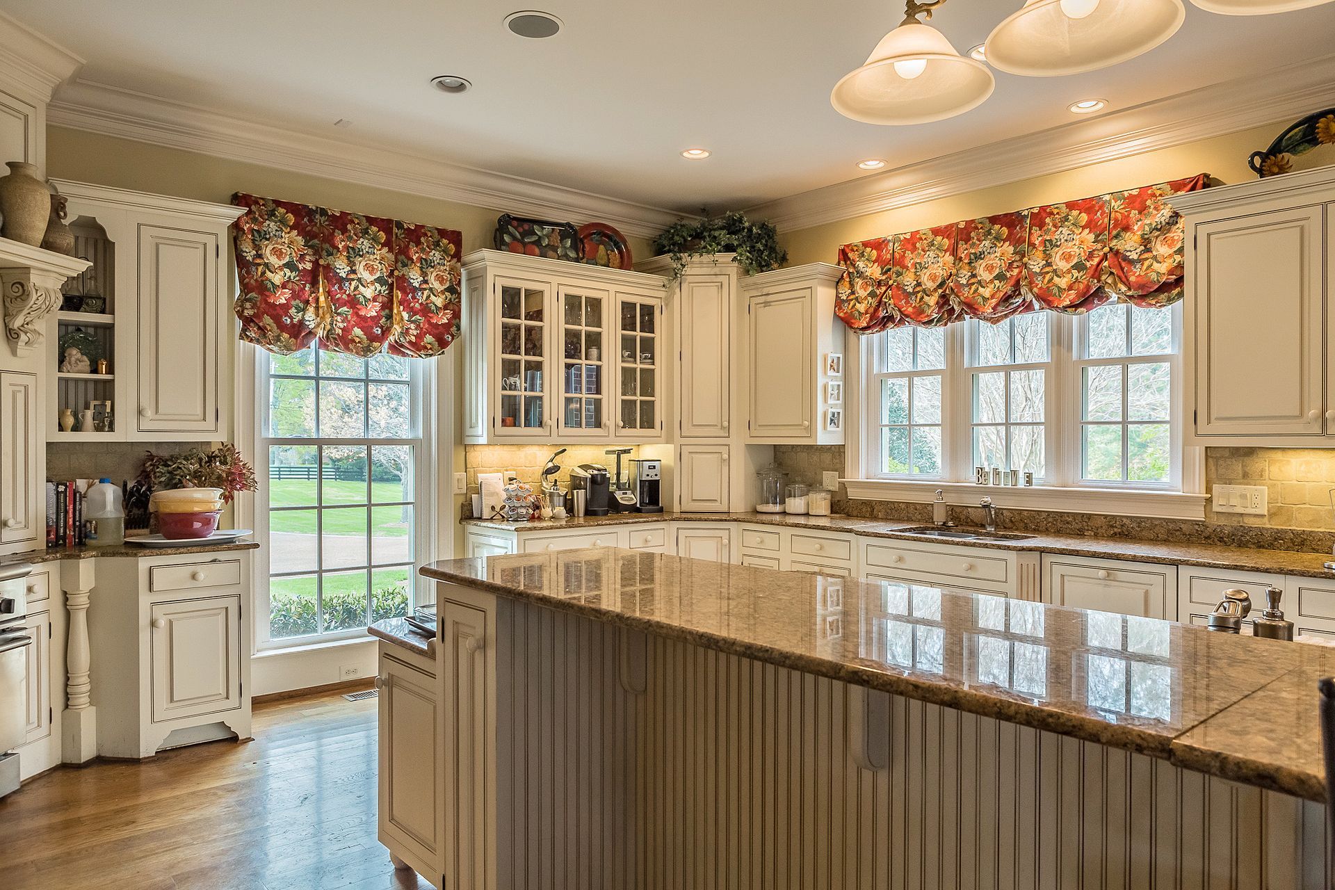 A kitchen with white cabinets and granite counter tops