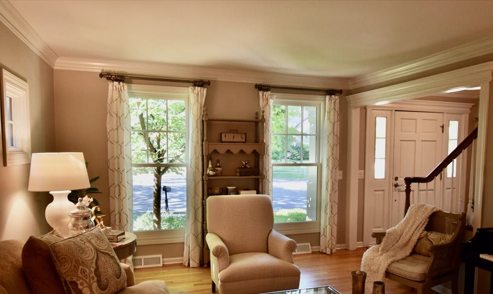 A living room with a couch and two chairs