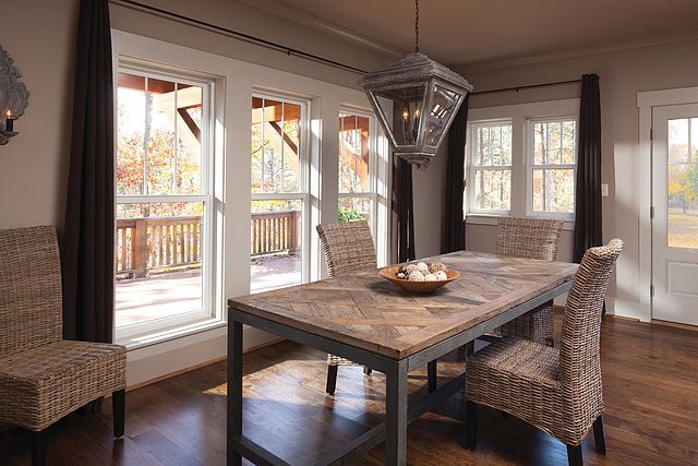 A dining room with a table and chairs and a chandelier.
