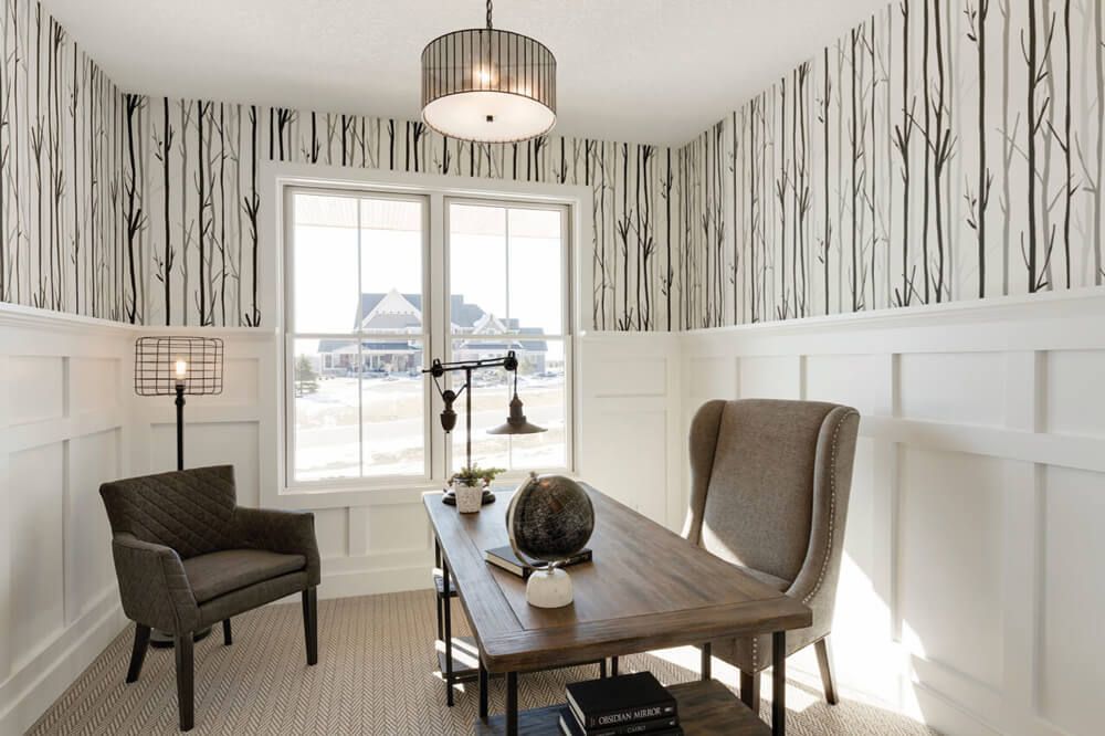 A home office with a wooden desk and chairs