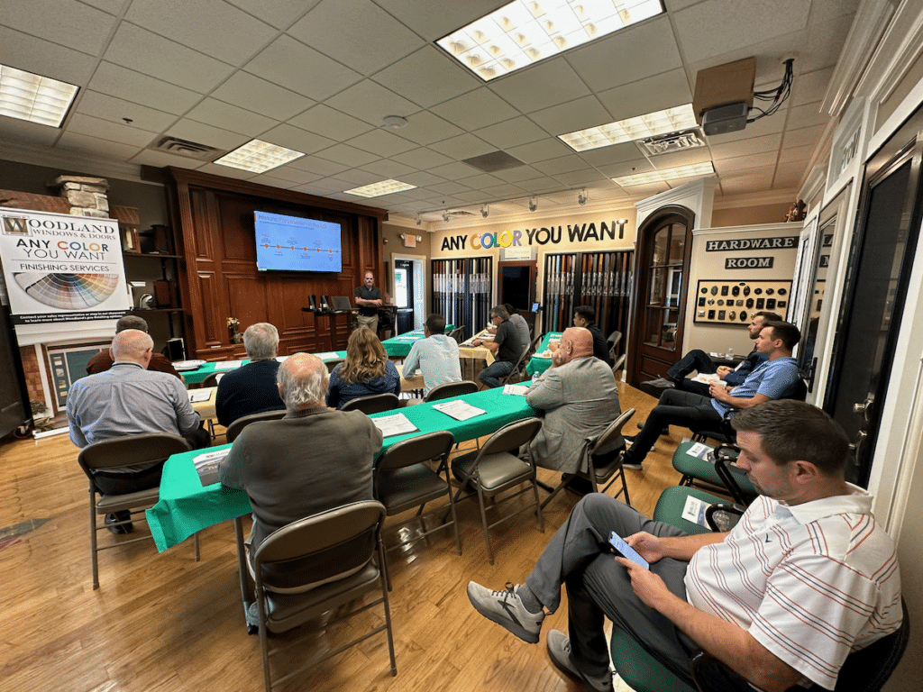 A group of people are sitting at tables in a room.