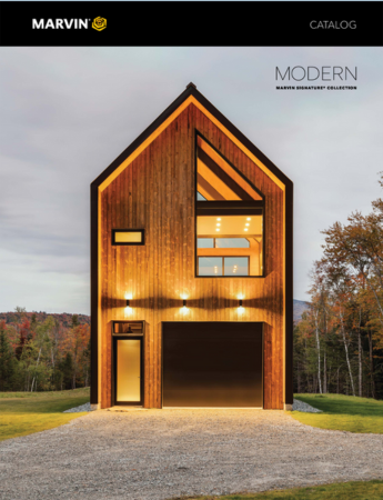 A modern wooden house with a black garage door