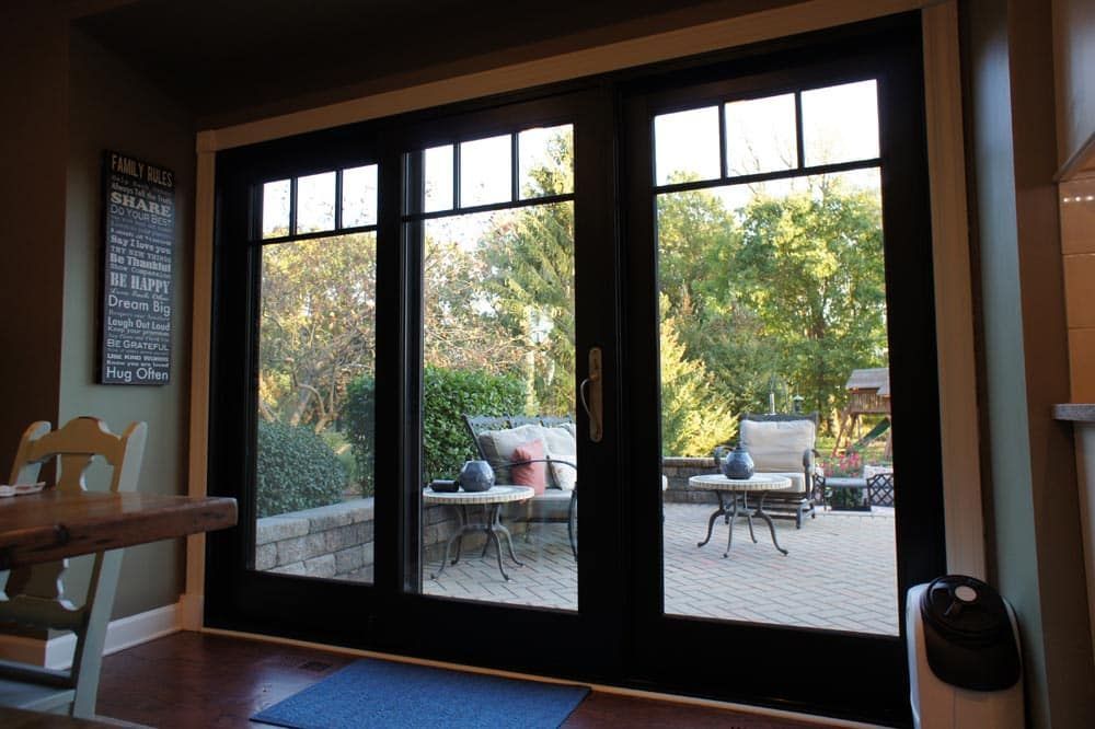 A room with sliding glass doors leading to a patio.