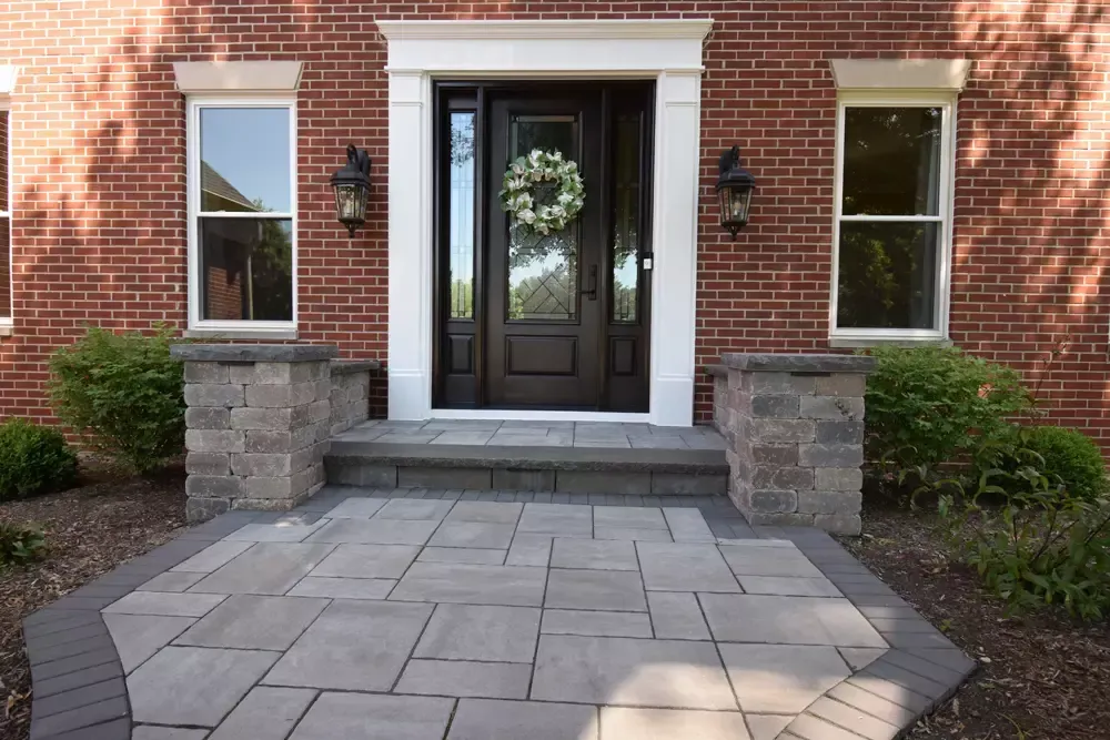The front door of a brick house with a wreath on it