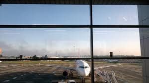 An airplane is parked on the tarmac at an airport.