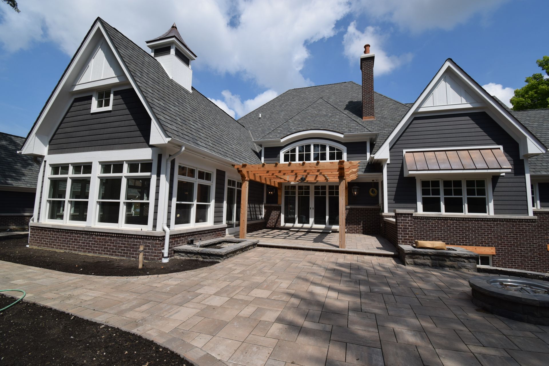 A large house with a gray roof and white trim