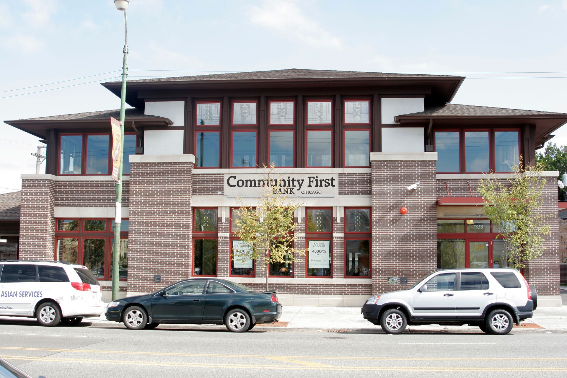 Cars are parked in front of a building that says currently filed