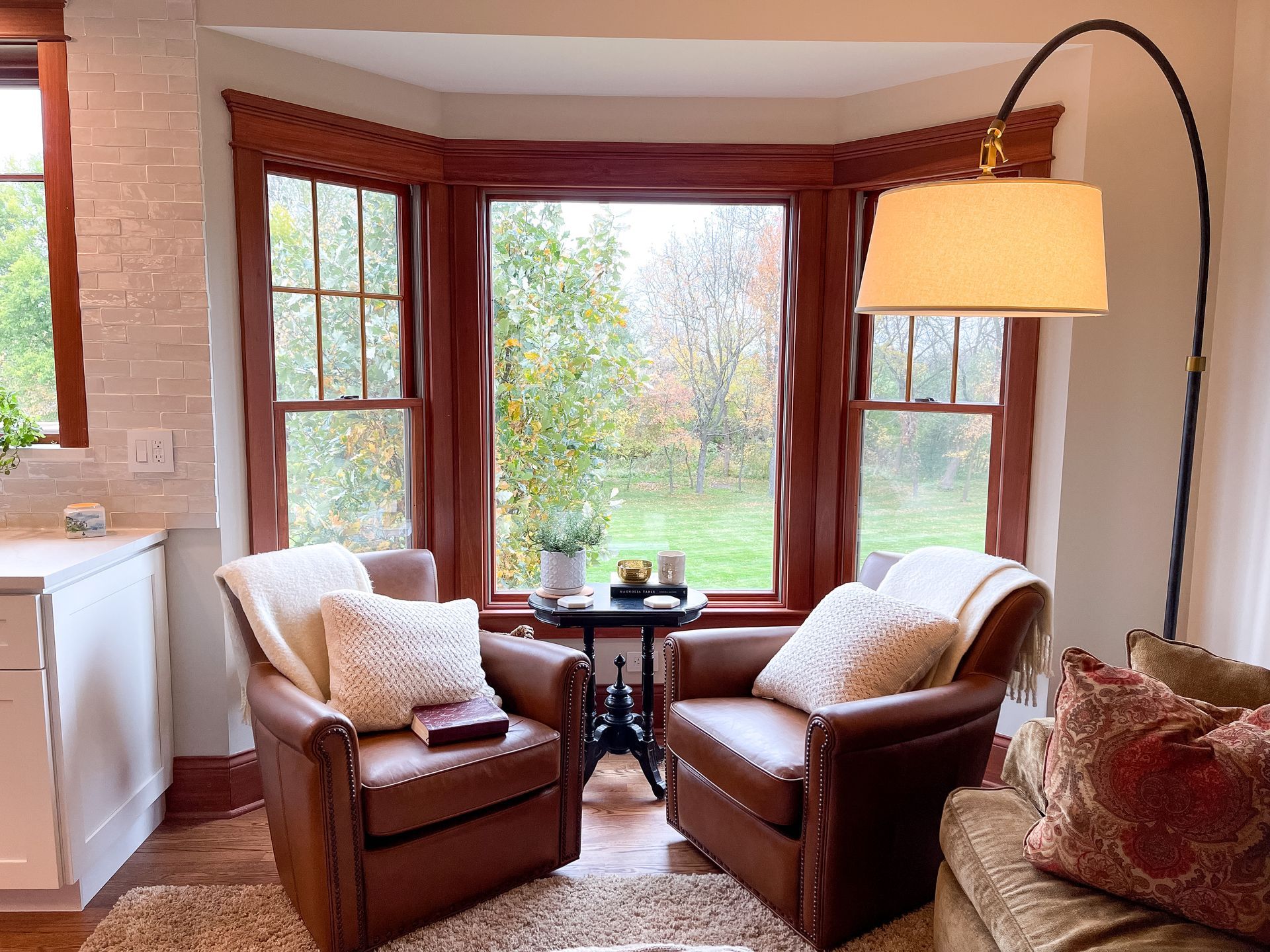 A living room with two chairs and a lamp