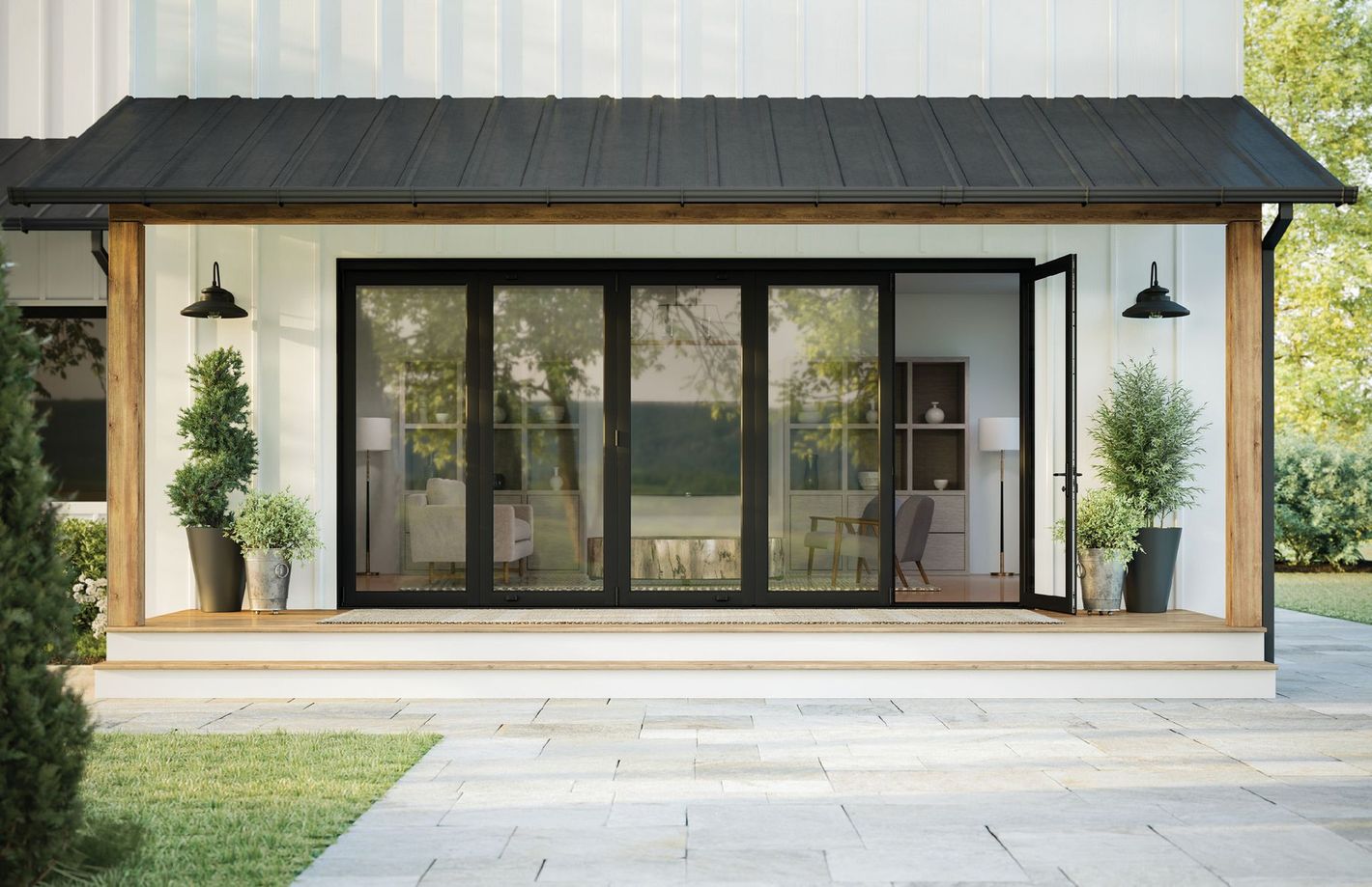 A white house with a black roof and sliding glass doors.