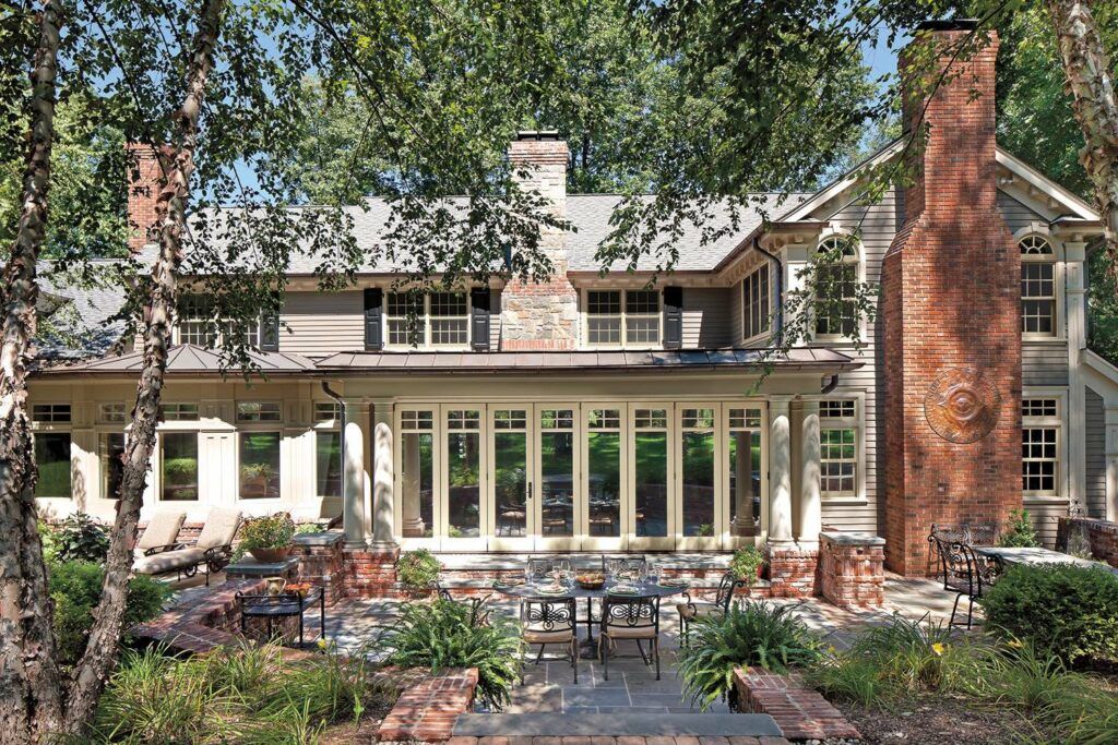 A large house with a lot of windows and a brick chimney