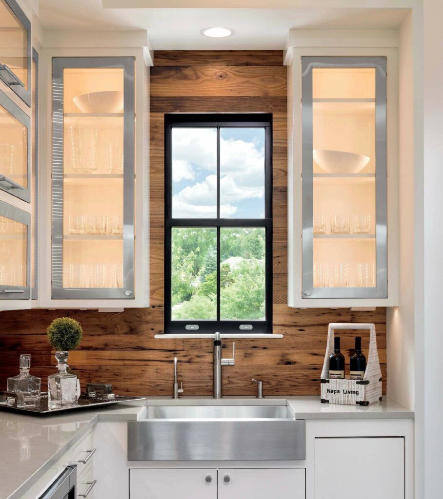 A kitchen with a stainless steel sink and a window