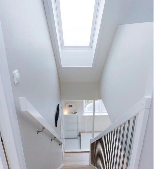 A staircase with a skylight in the ceiling