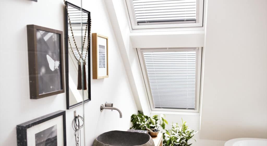 A bathroom with a sink and a window with blinds