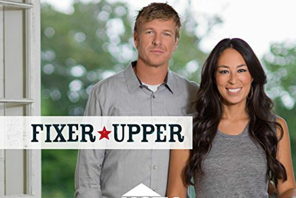 A man and a woman are standing next to each other in front of a sign that says fixer upper