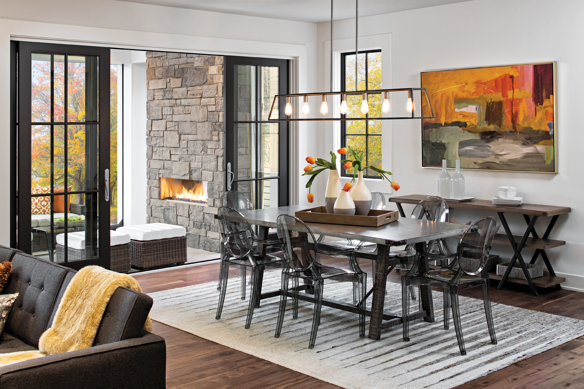 A living room with a dining room table and chairs and a fireplace.