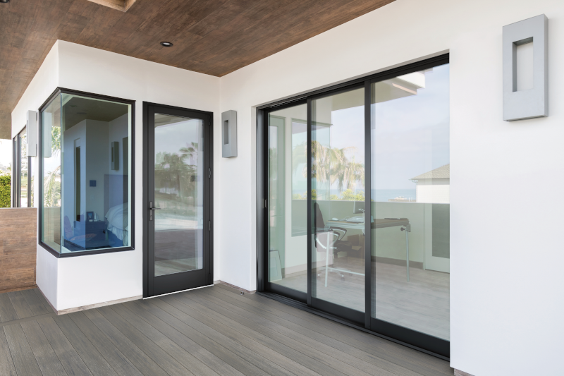 A white house with sliding glass doors and a wooden floor.