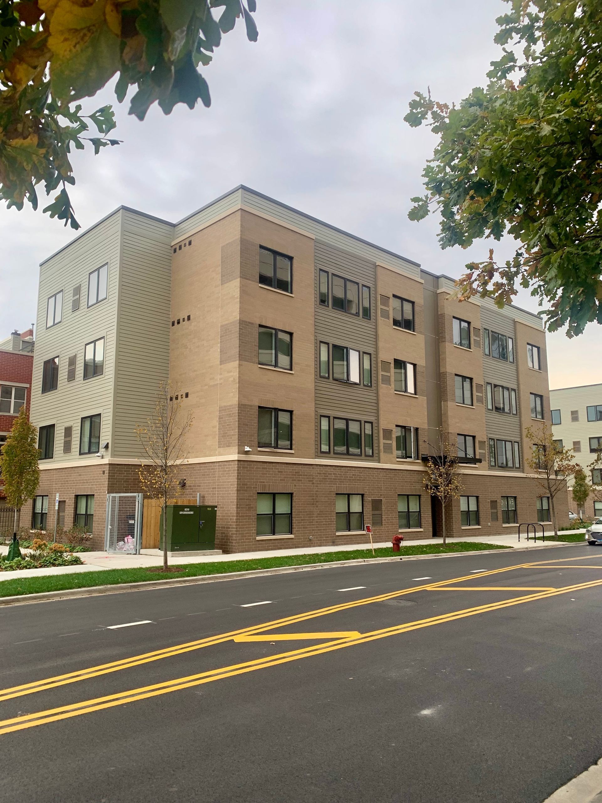 A large apartment building with a fire hydrant in front of it