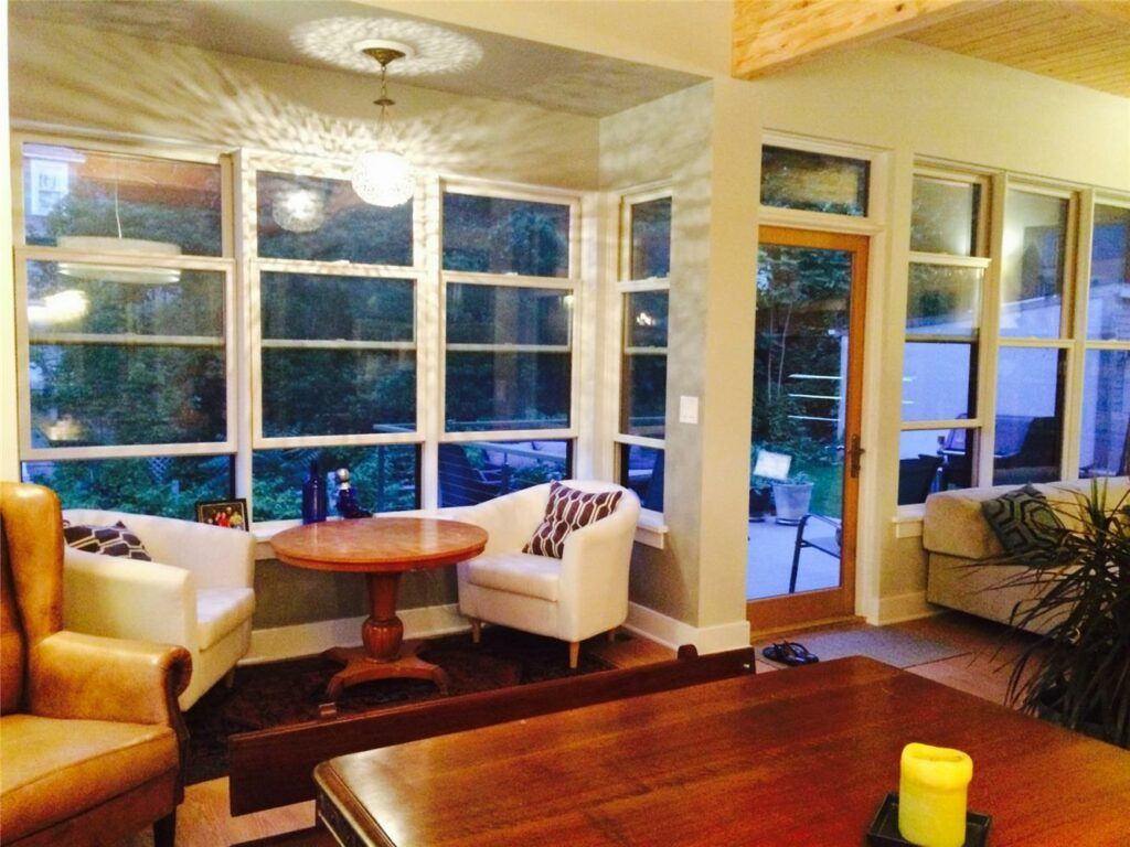 A living room with a table , chairs , and a candle.