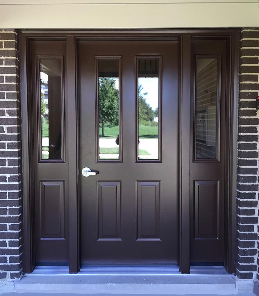 A brown door with a brick wall behind it