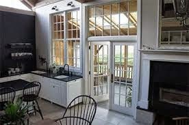 A kitchen with a table and chairs and a fireplace.