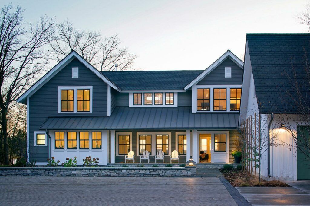 A large gray and white house with a blue roof