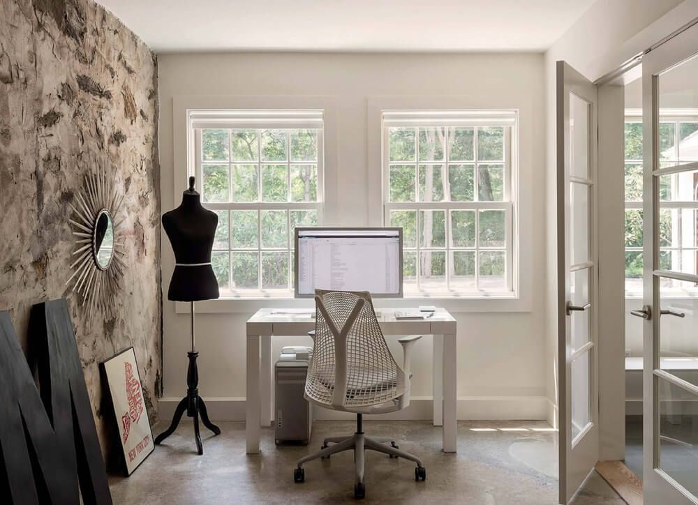 A room with a desk and chair and a computer on it