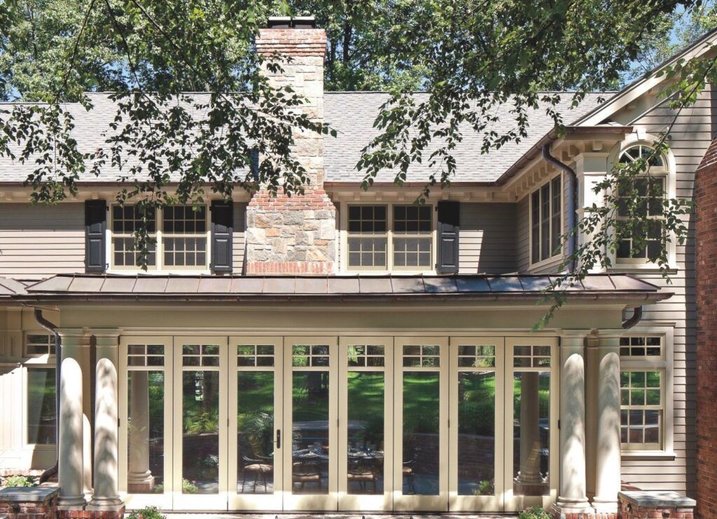 A house with a lot of windows and a chimney