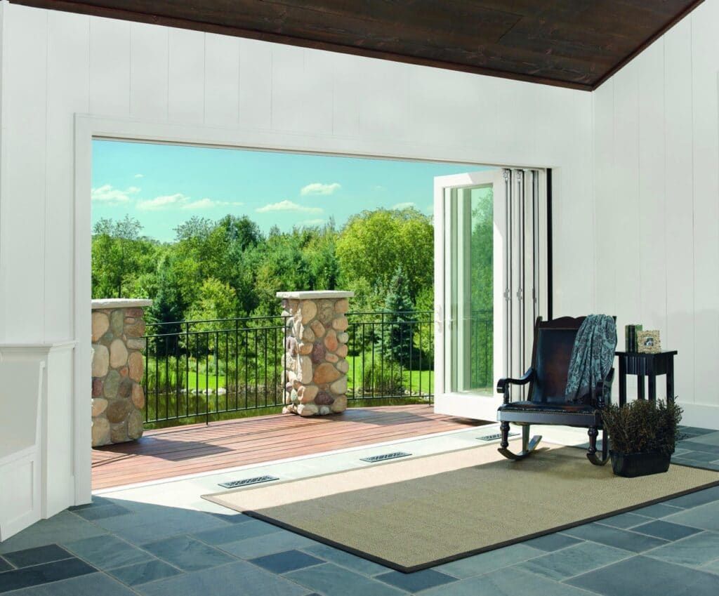 A living room with a rocking chair and sliding glass doors leading to a patio.