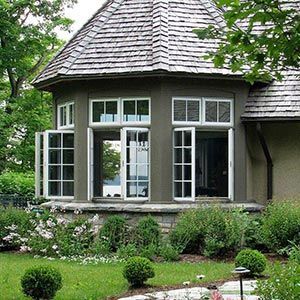 A house with a wooden roof and a lot of windows.