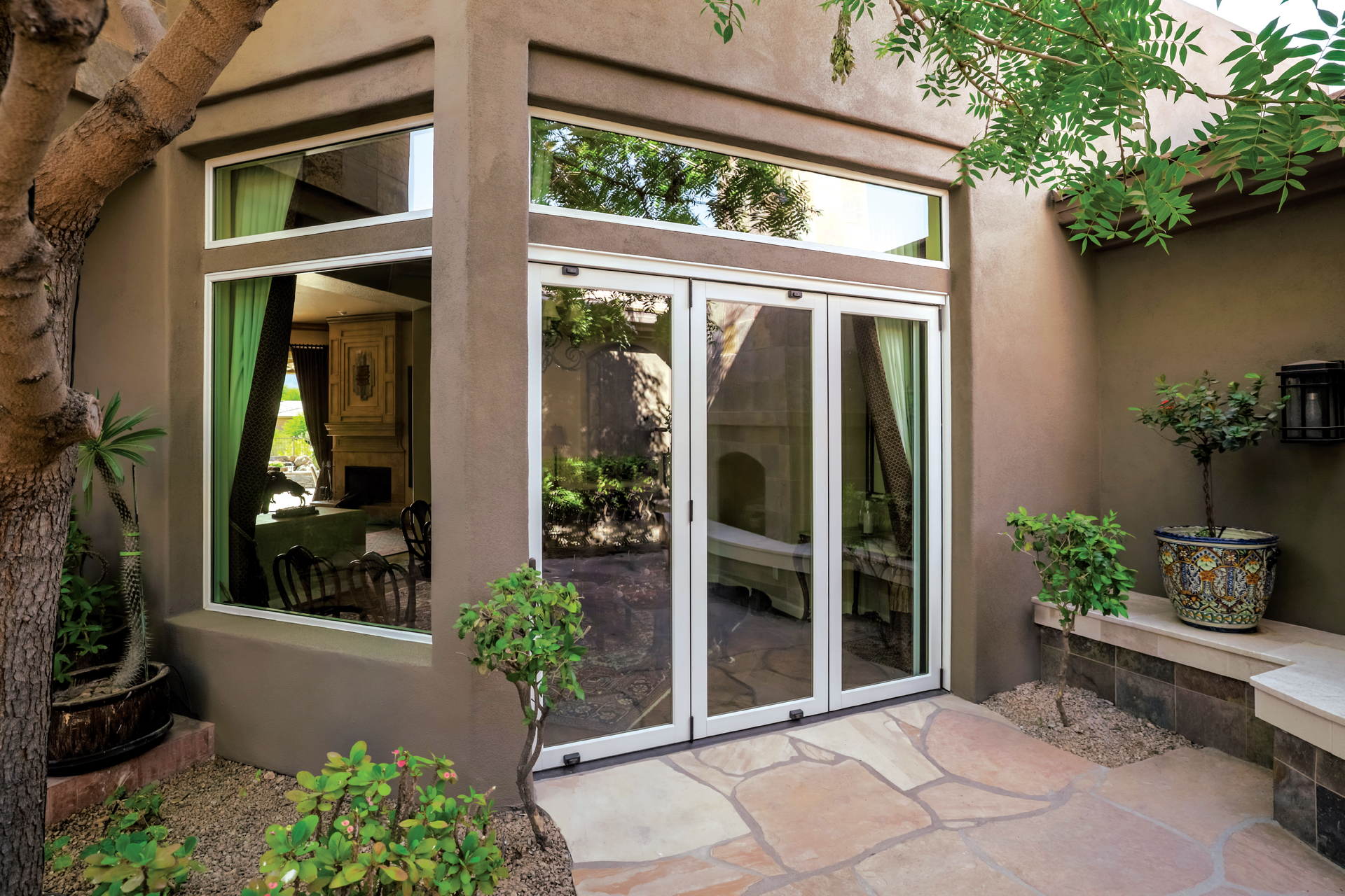 A house with a lot of windows and sliding glass doors