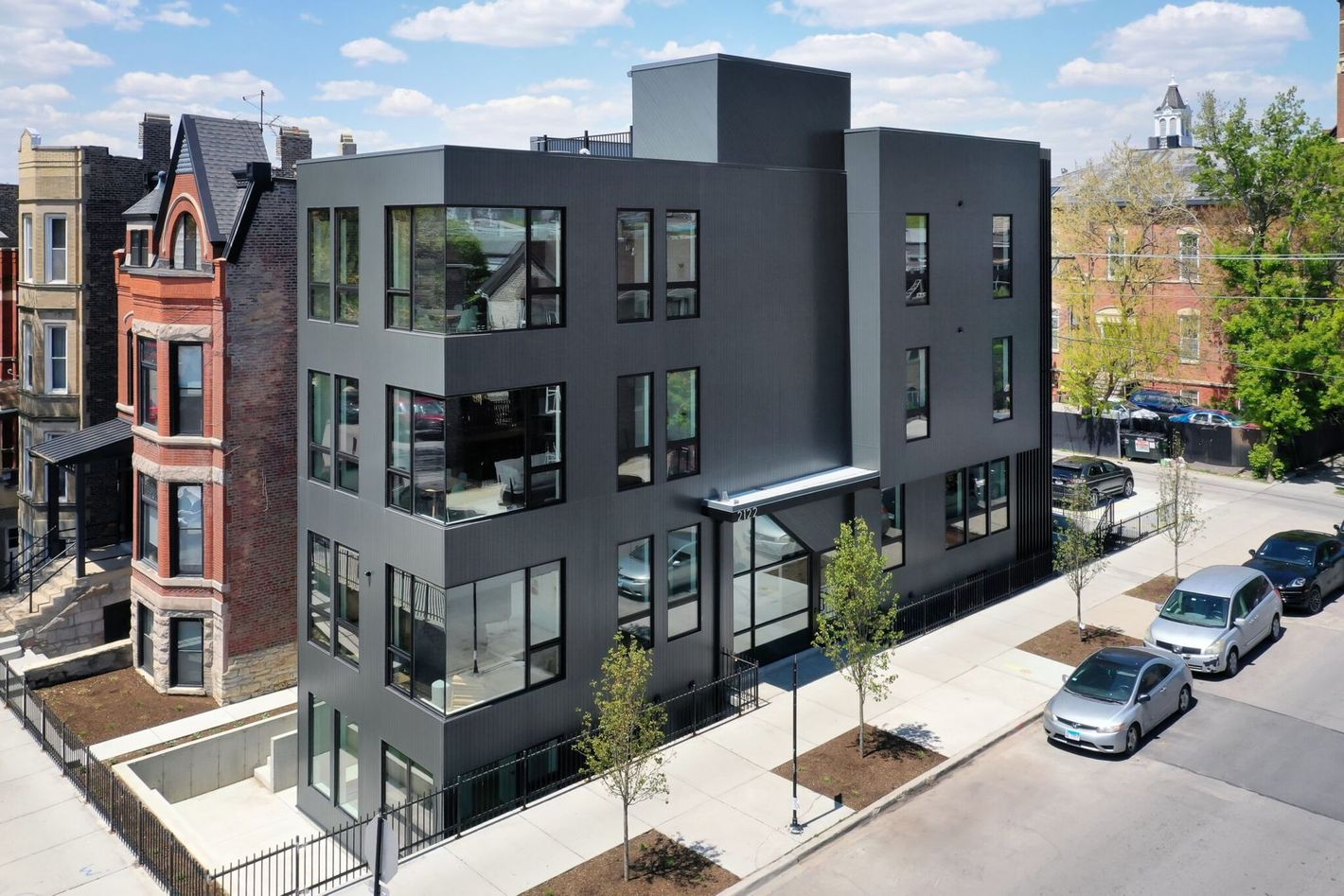 An aerial view of a building with cars parked in front of it