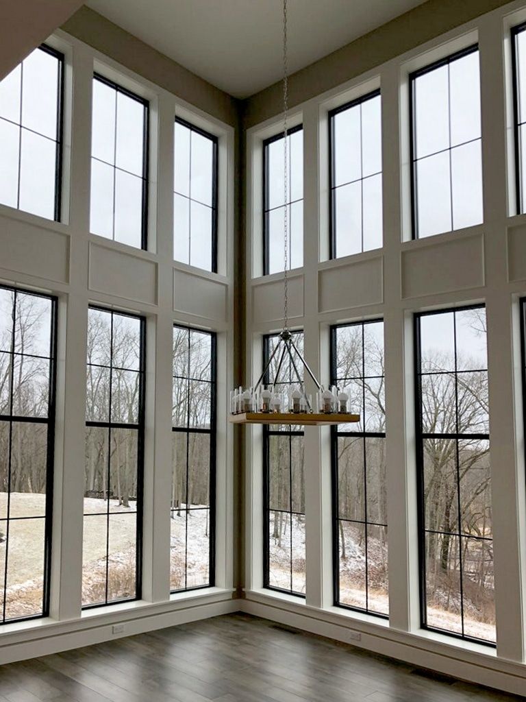 A room with a lot of windows and a chandelier hanging from the ceiling.