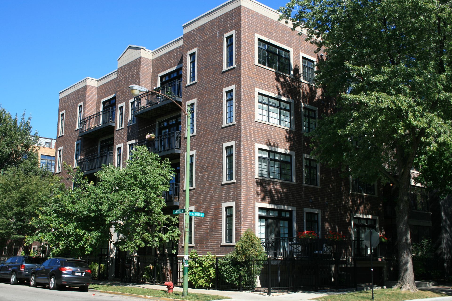 A large brick building with cars parked in front of it