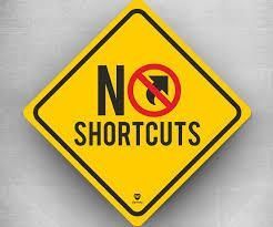 A yellow sign that says `` no shortcuts '' on it.