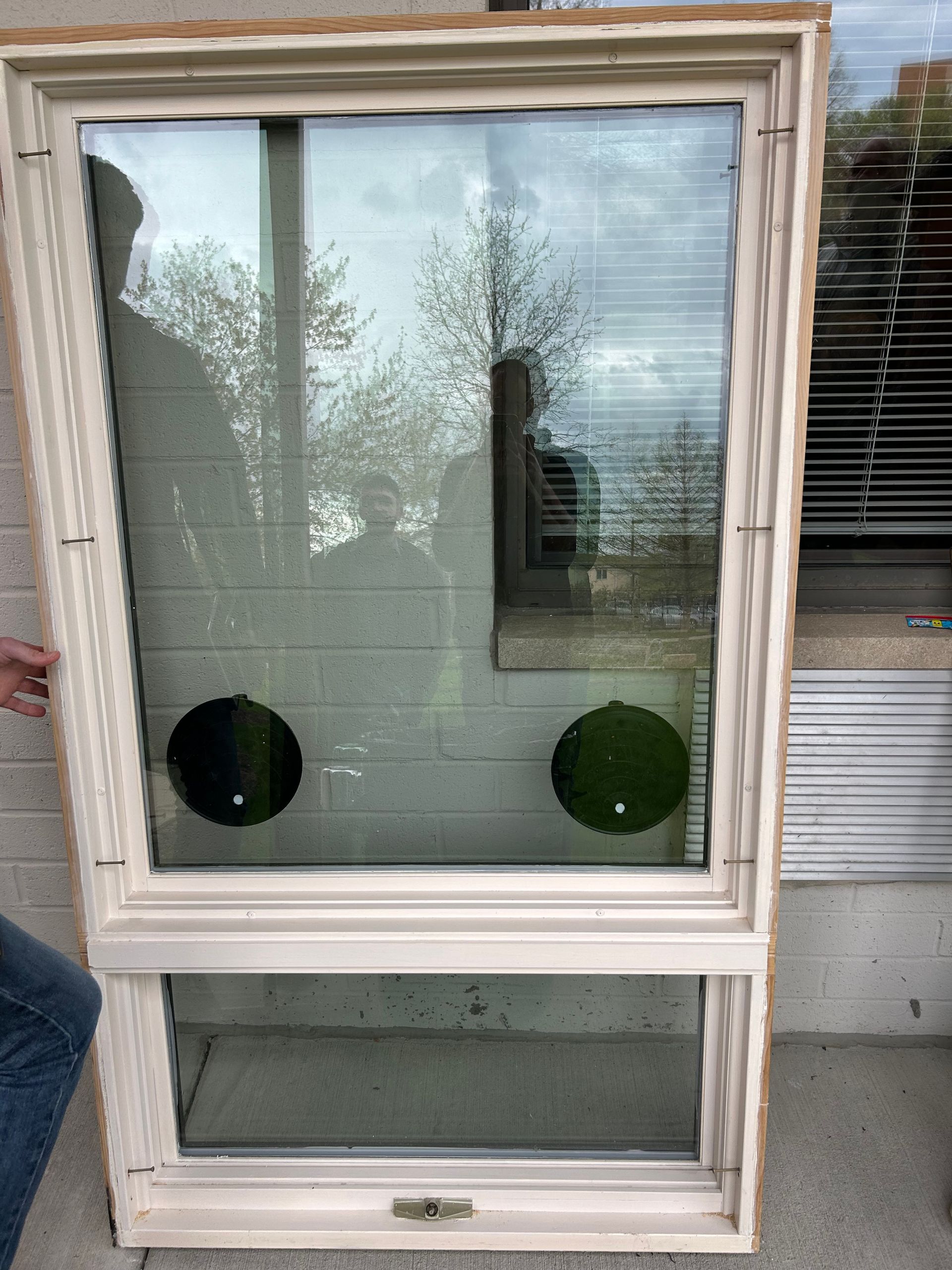 A living room with a couch , chair , table and sliding glass doors leading to a porch.