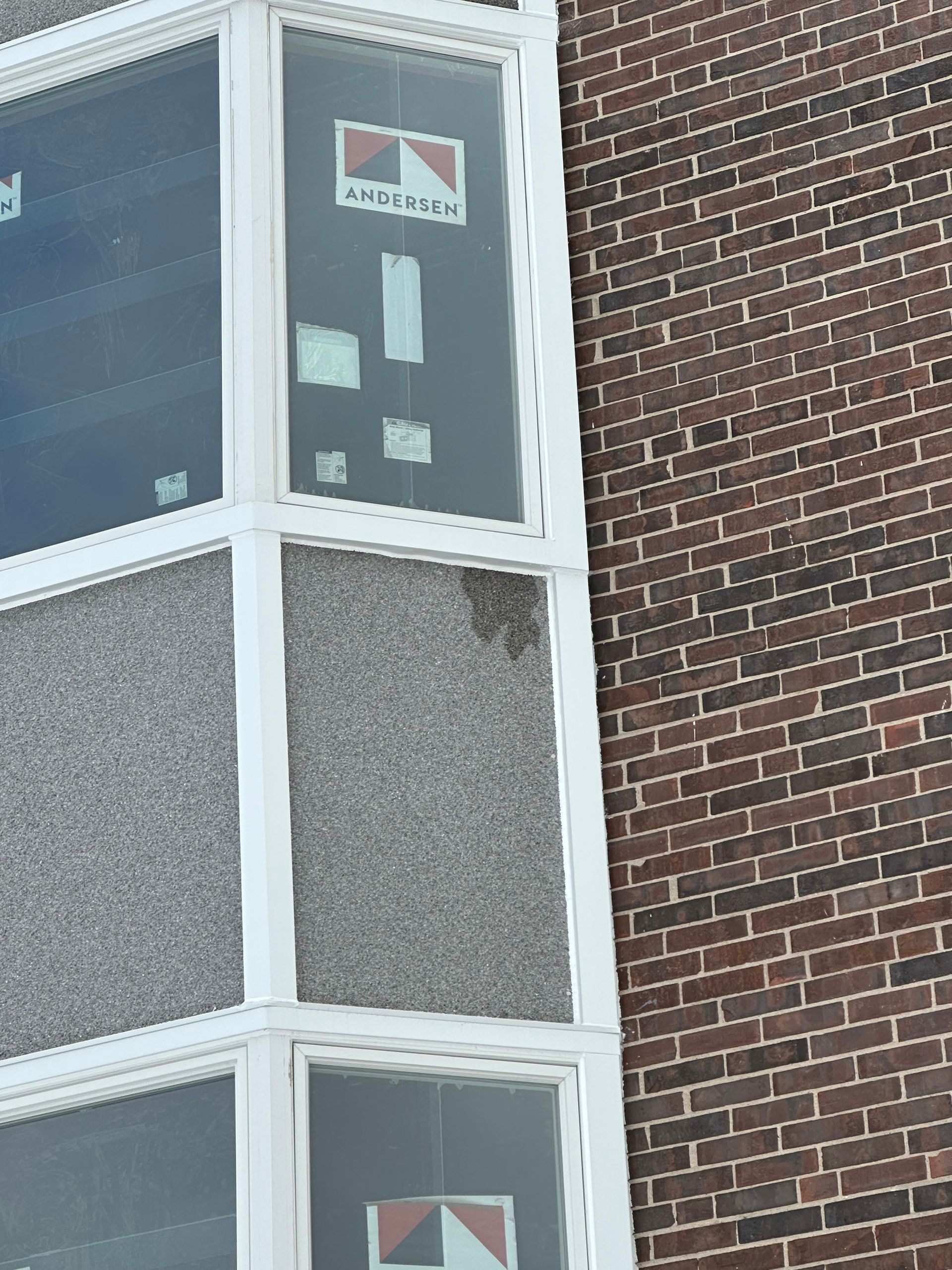 A living room with a couch , chair , table and sliding glass doors leading to a porch.