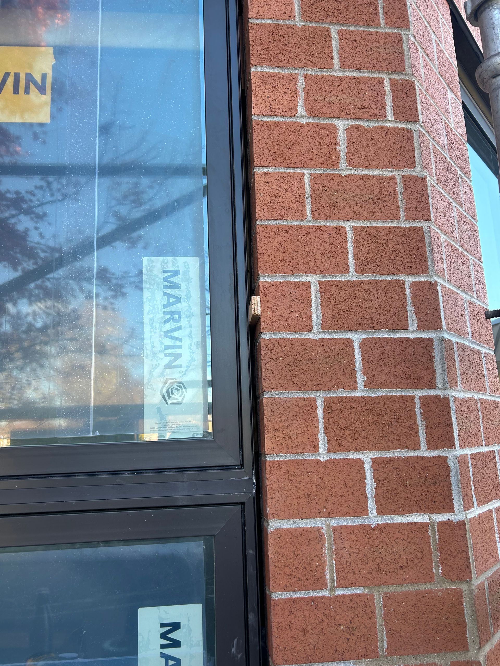 Brick building corner, black window frame with 