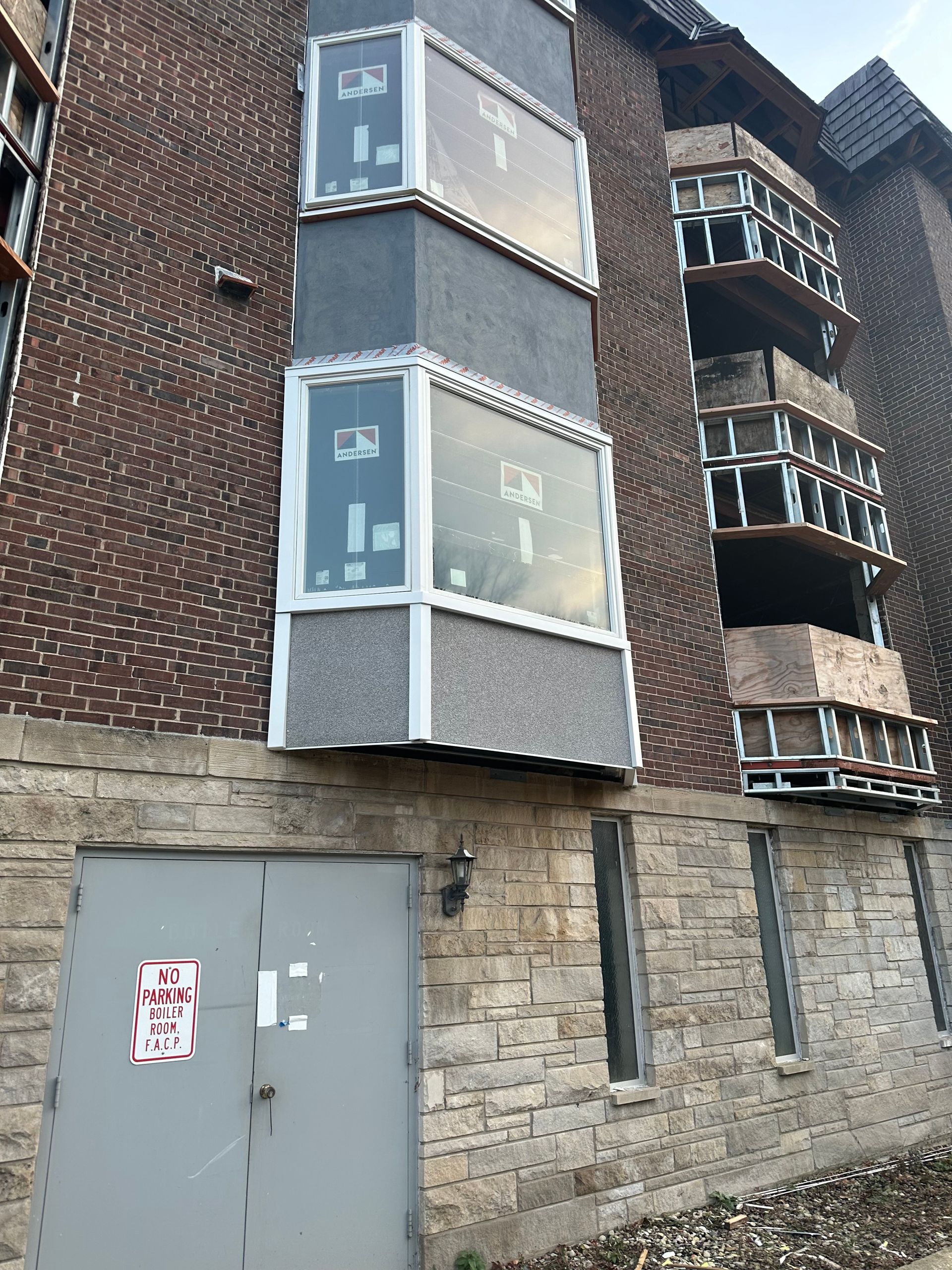 A bedroom with a large bed and sliding glass doors.