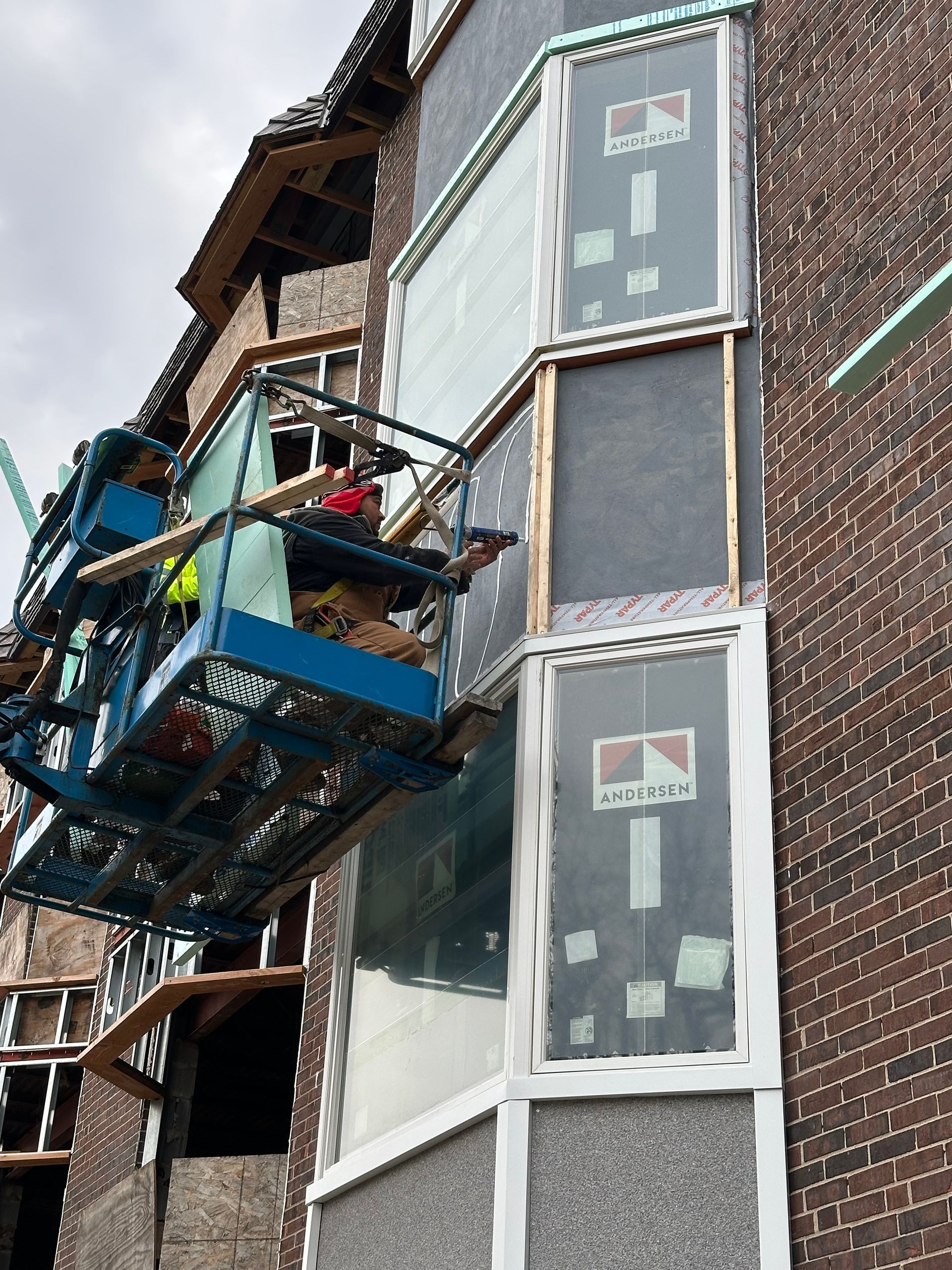 A living room with a dining room table and chairs and a fireplace.