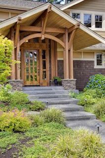 A house with a wooden porch and stairs leading up to it.