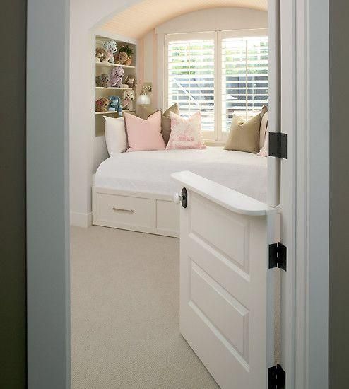 A bedroom with a bed and a window with blinds