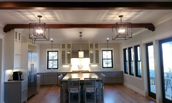 A kitchen with a large island and lots of windows