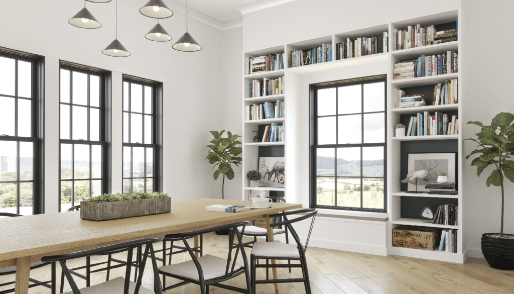 A dining room with a table and chairs and a bookshelf.