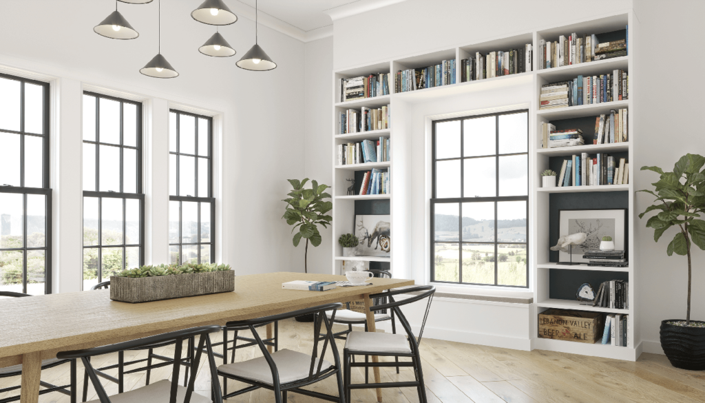 A dining room with a table and chairs and a bookshelf.